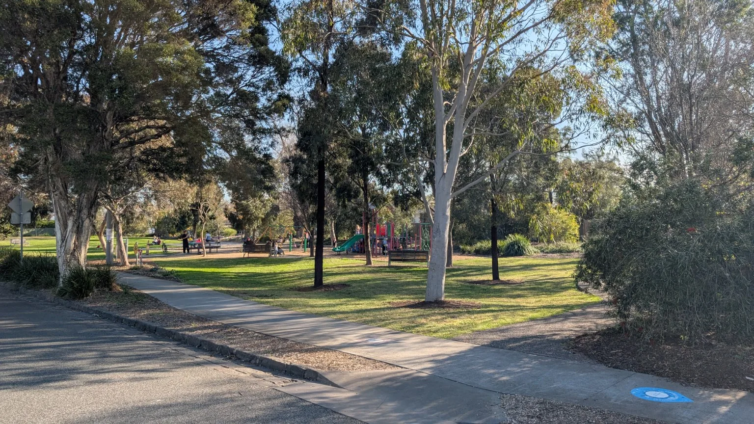 View from the street toward the playground and green open space on Wales Street