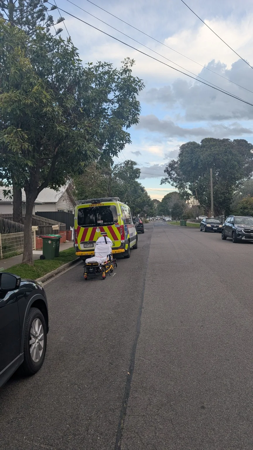 Ambulance stopped on a residential street near the Coronation Street area